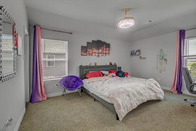 a view of a patio with table and chairs under an umbrella