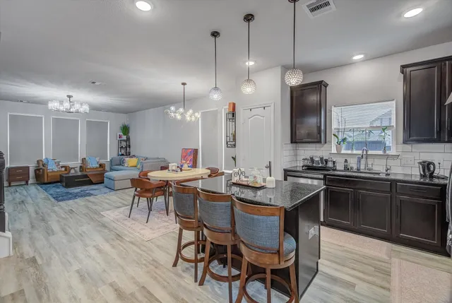 a dining room with furniture a rug and painting on the wall