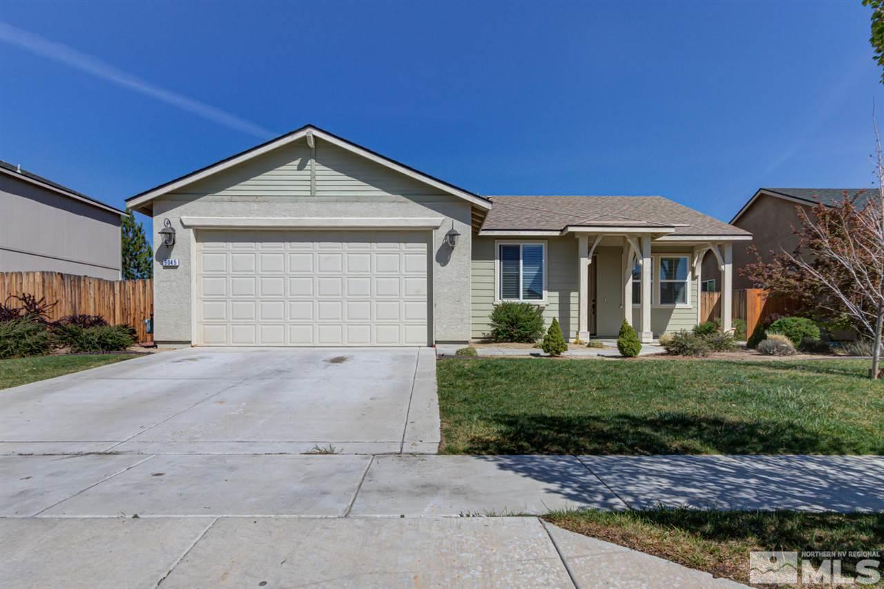 9045 Convair Way Reno, NV 89506 - Photo 1 of 34 a front view of a house with a yard and garage