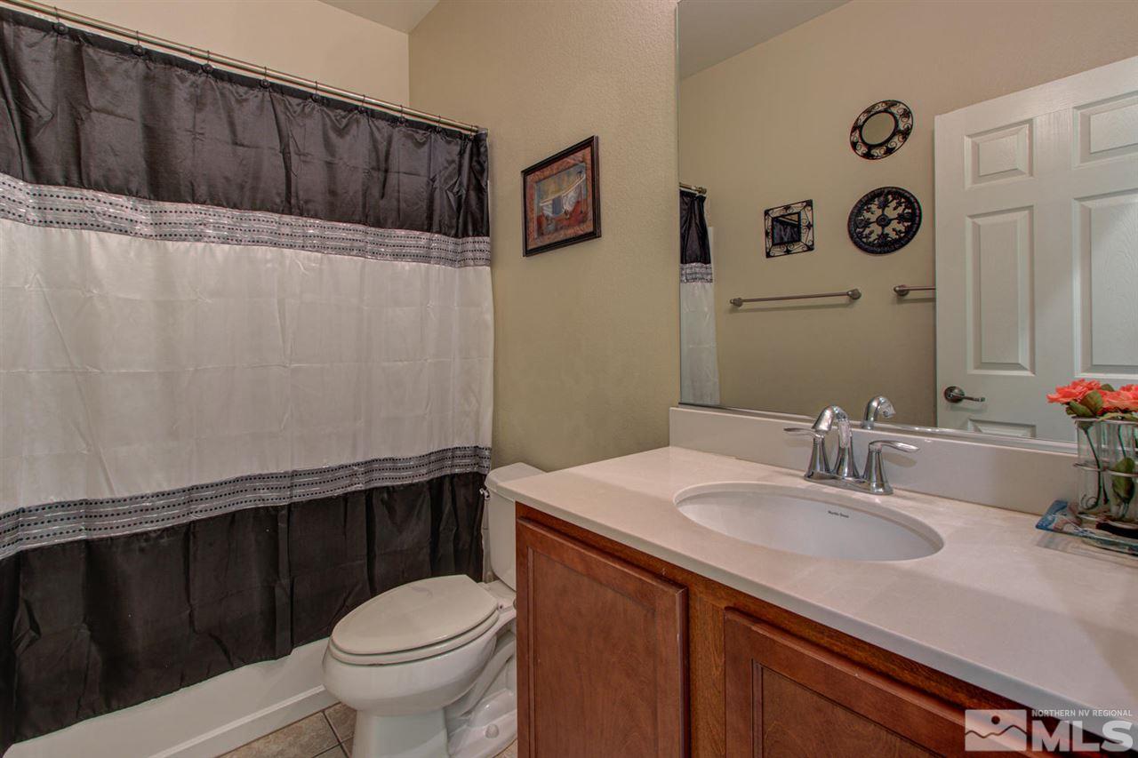 9045 Convair Way Reno, NV 89506 - Photo 18 of 34 a bathroom with a sink toilet and vanity