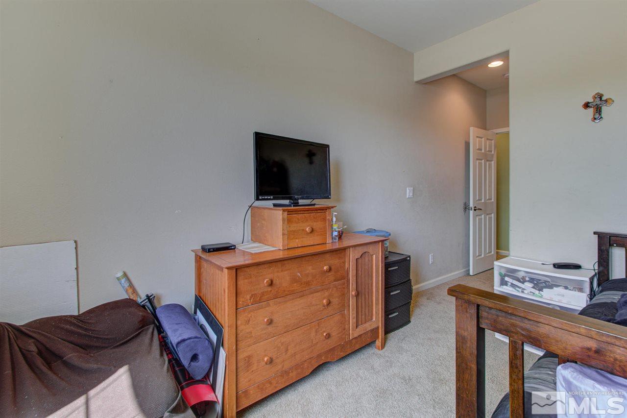 9045 Convair Way Reno, NV 89506 - Photo 20 of 34 a room with a bed and a television