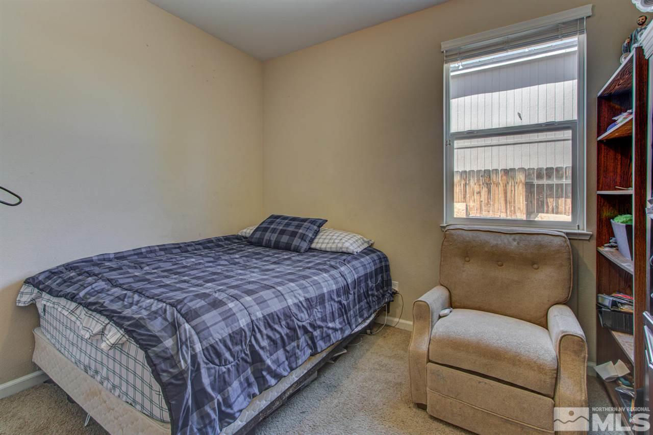 9045 Convair Way Reno, NV 89506 - Photo 21 of 34 a bedroom with a bed couch and window