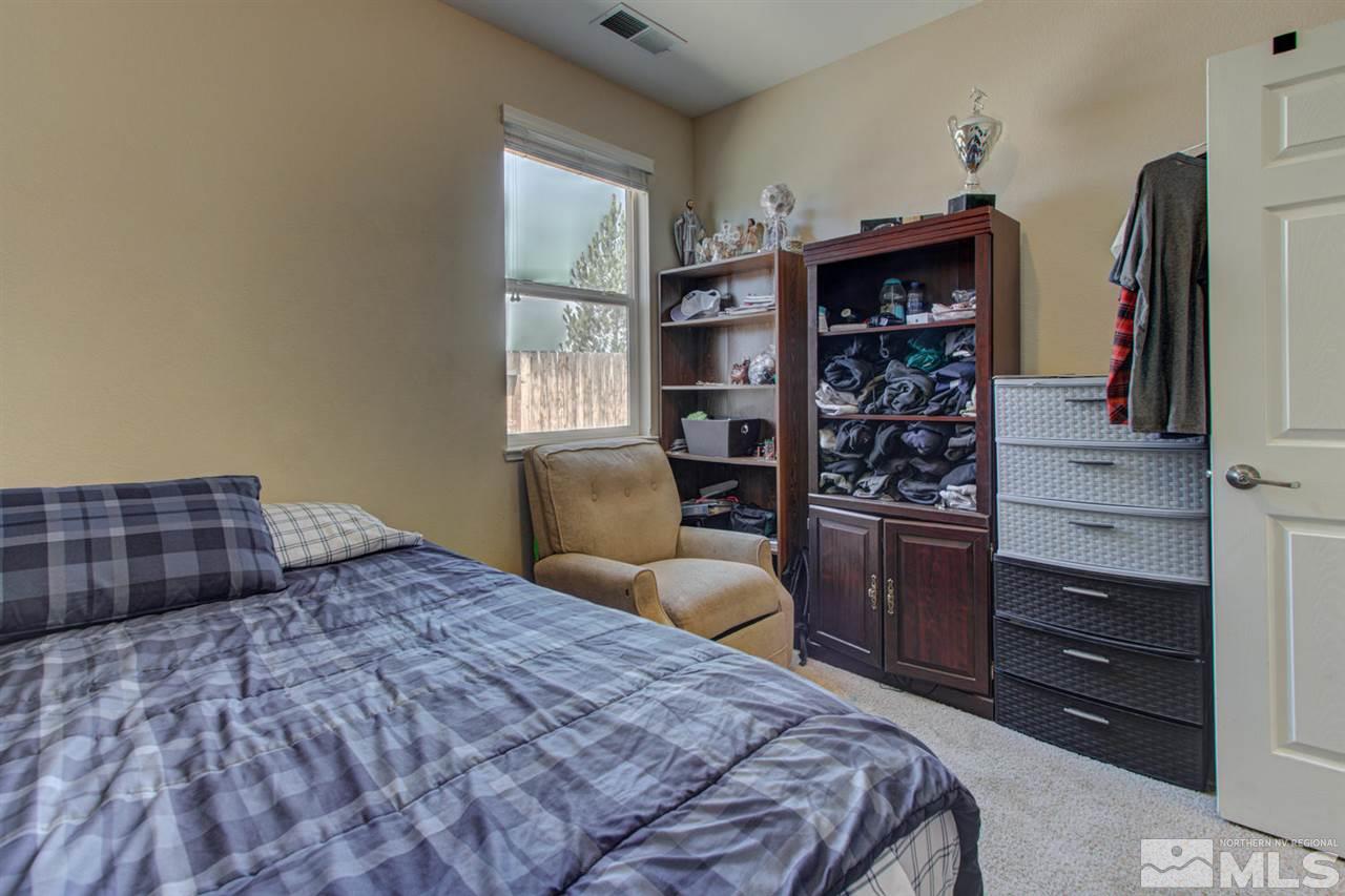9045 Convair Way Reno, NV 89506 - Photo 22 of 34 a bedroom with a bed and a television