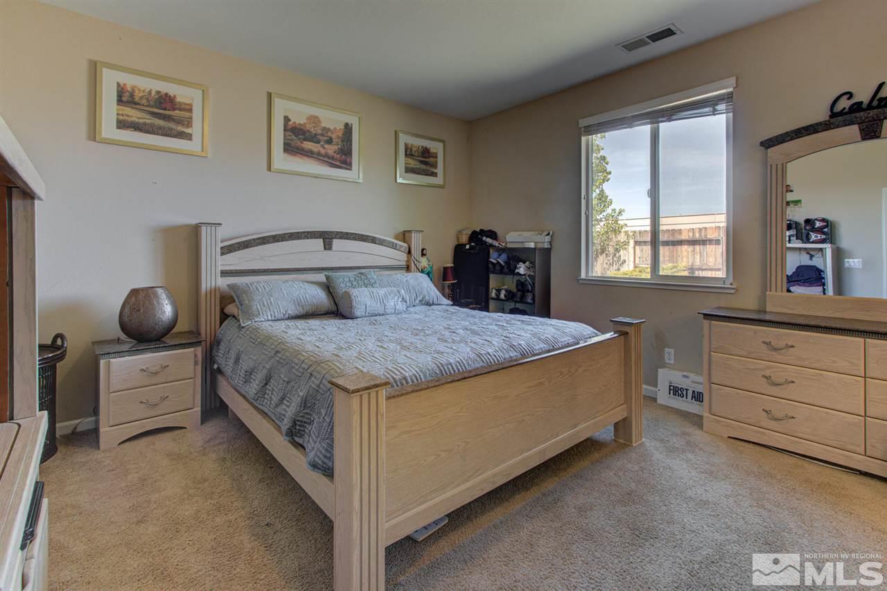 9045 Convair Way Reno, NV 89506 - Photo 23 of 34 a bedroom with a bed and window