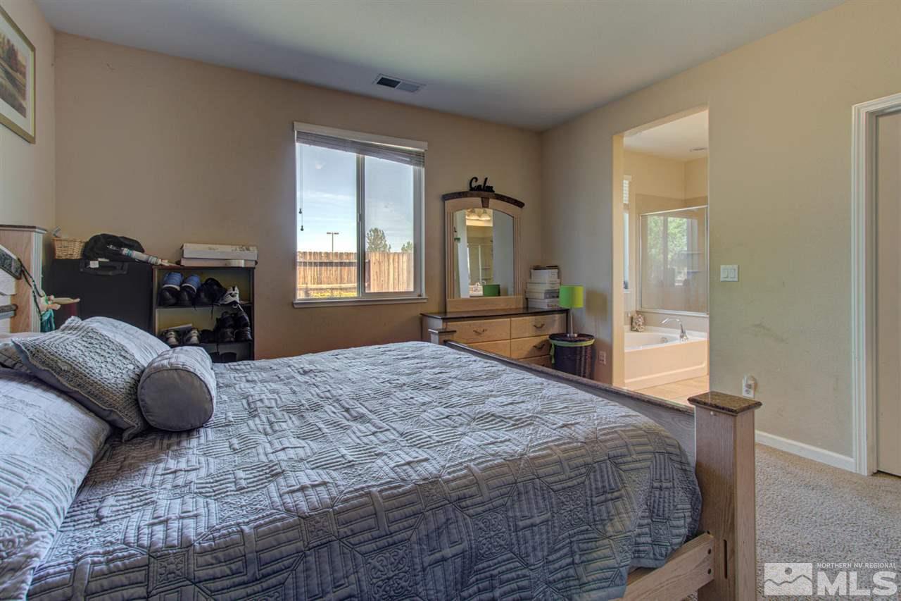 9045 Convair Way Reno, NV 89506 - Photo 24 of 34 a bedroom with a bed and wooden floor