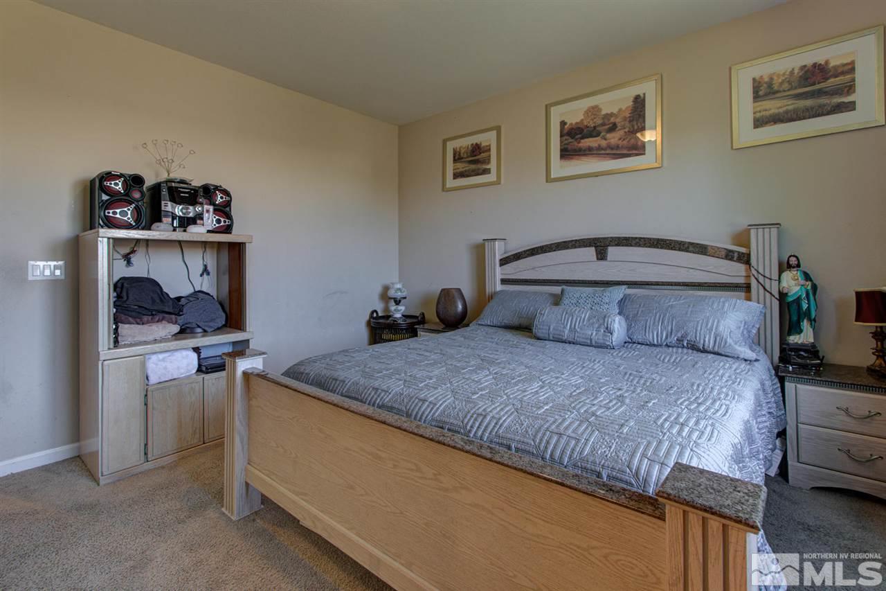 9045 Convair Way Reno, NV 89506 - Photo 25 of 34 a bedroom with a bed and a table in it