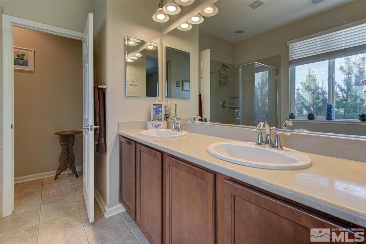 9045 Convair Way Reno, NV 89506 - Photo 27 of 34 a bathroom with a double vanity sink and a mirror