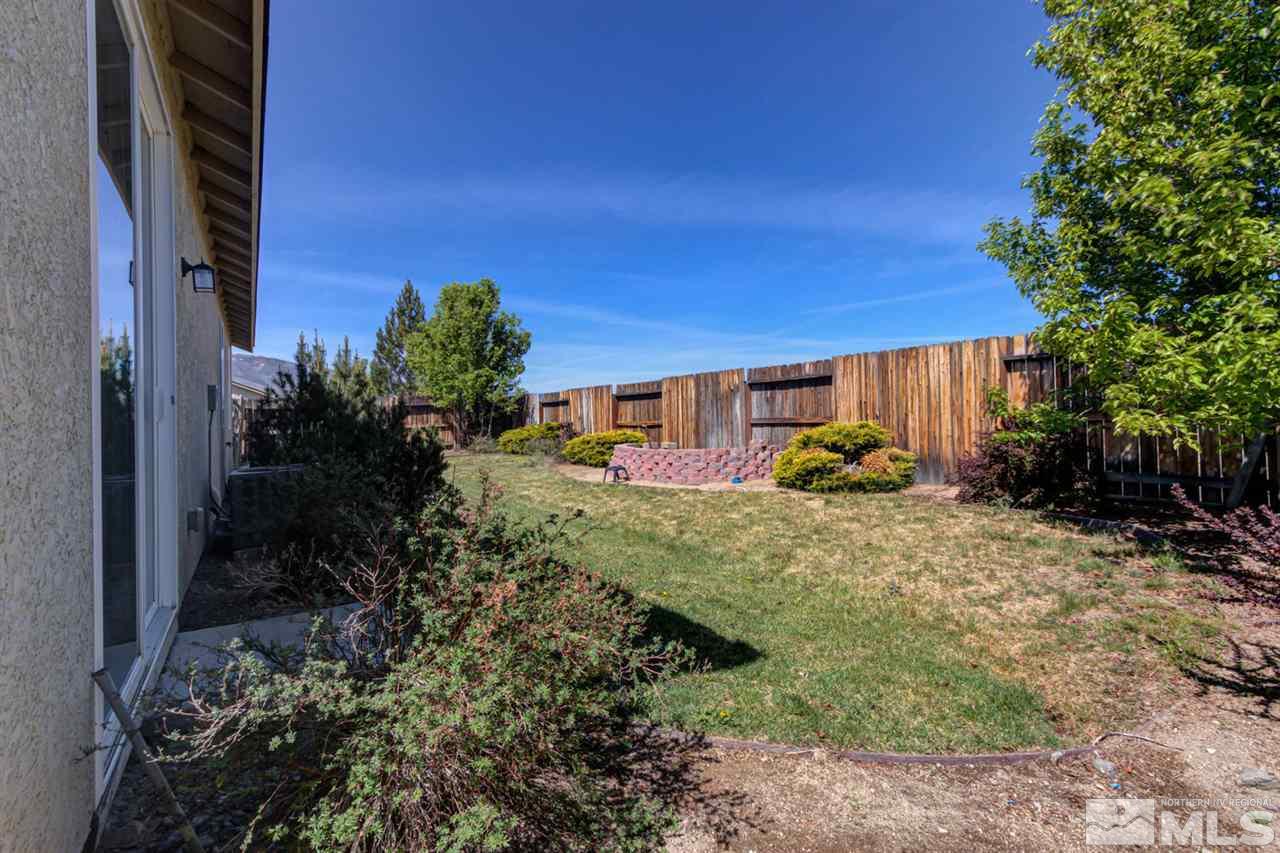 9045 Convair Way Reno, NV 89506 - Photo 30 of 34 a backyard of a house with a yard and outdoor seating