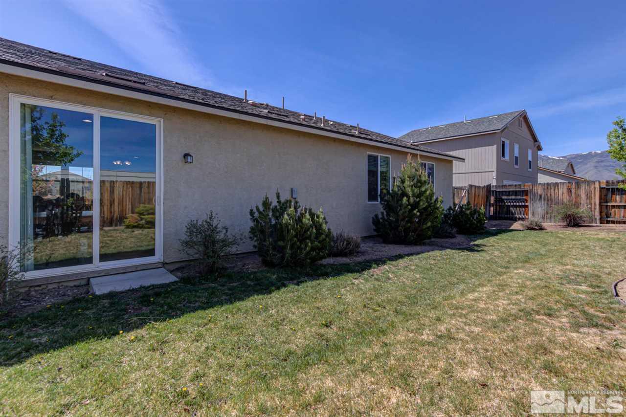 9045 Convair Way Reno, NV 89506 - Photo 31 of 34 a backyard of a house with potted plants and a bench