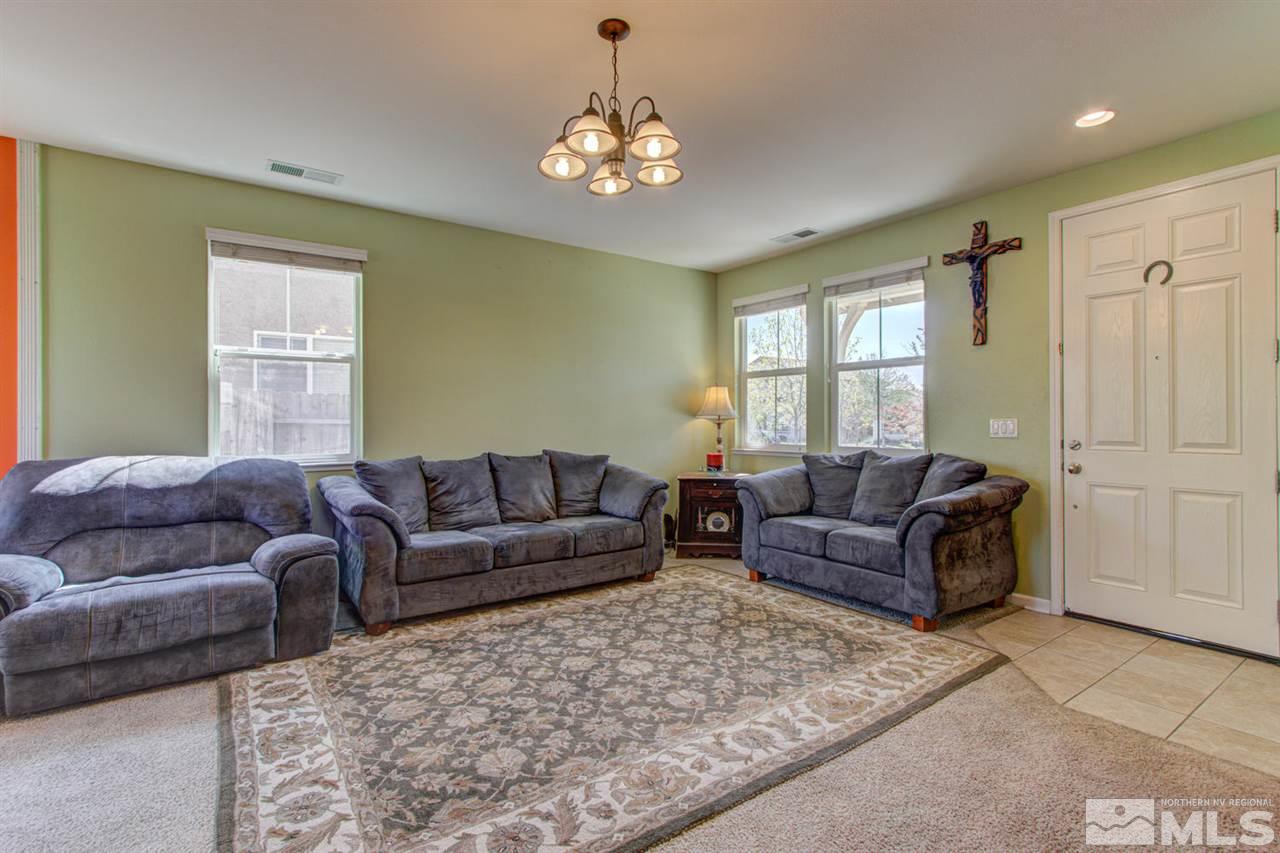 9045 Convair Way Reno, NV 89506 - Photo 5 of 34 a living room with furniture and a chandelier