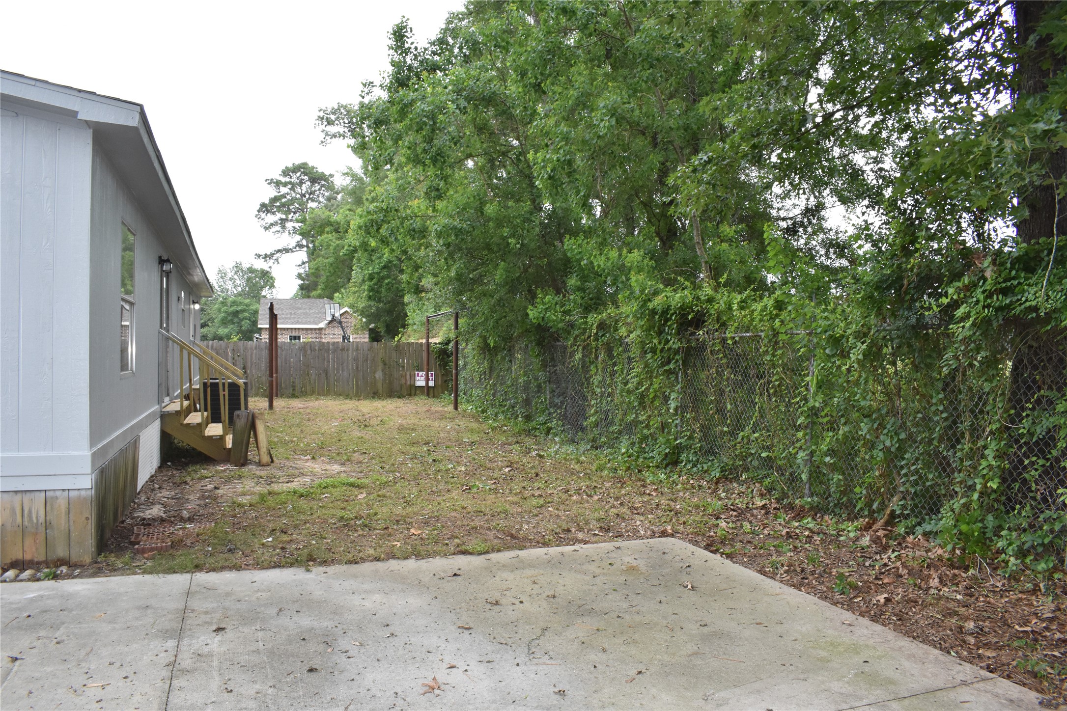 22536 Yancy Road Porter, TX 77365 - Photo 11 of 50 a backyard of a house with lots of green space