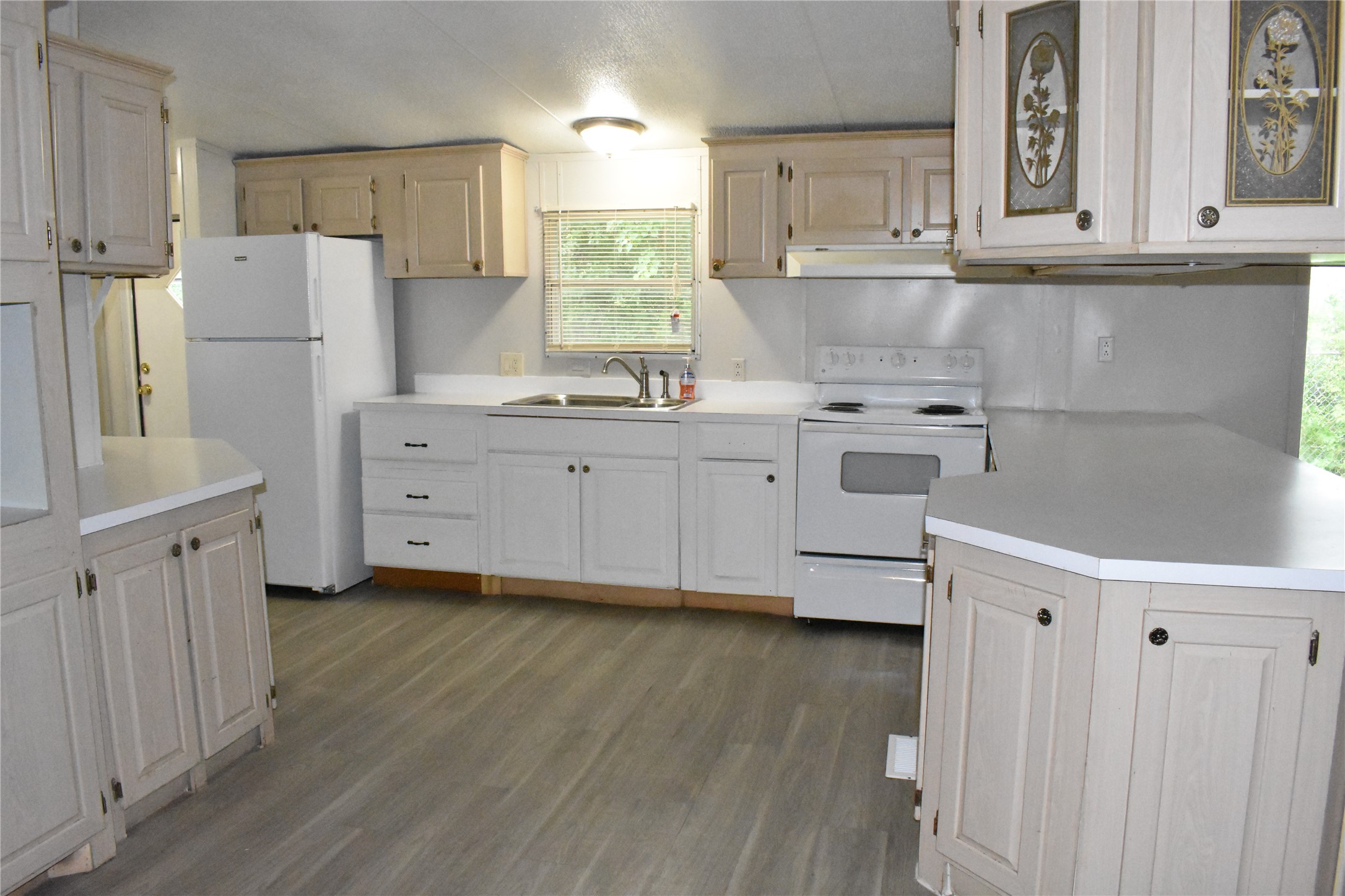 22536 Yancy Road Porter, TX 77365 - Photo 17 of 50 a kitchen with white cabinets and white appliances