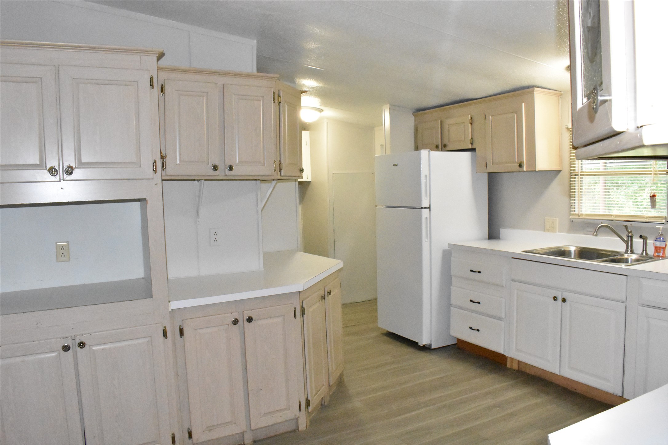 22536 Yancy Road Porter, TX 77365 - Photo 19 of 50 a kitchen with white cabinets and refrigerator