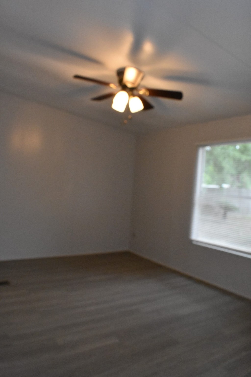 22536 Yancy Road Porter, TX 77365 - Photo 31 of 50 a view of an empty room with wooden floor and a window