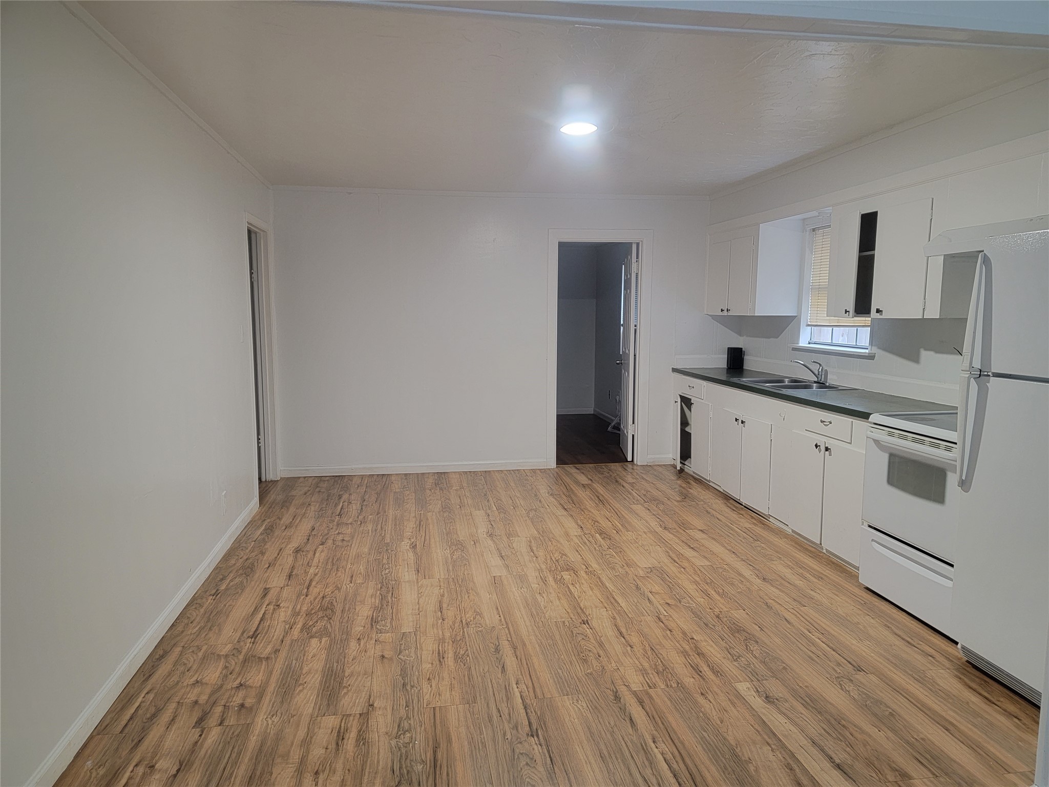 22536 Yancy Road Porter, TX 77365 - Photo 41 of 50 a kitchen with a sink a stove cabinets and wooden floor