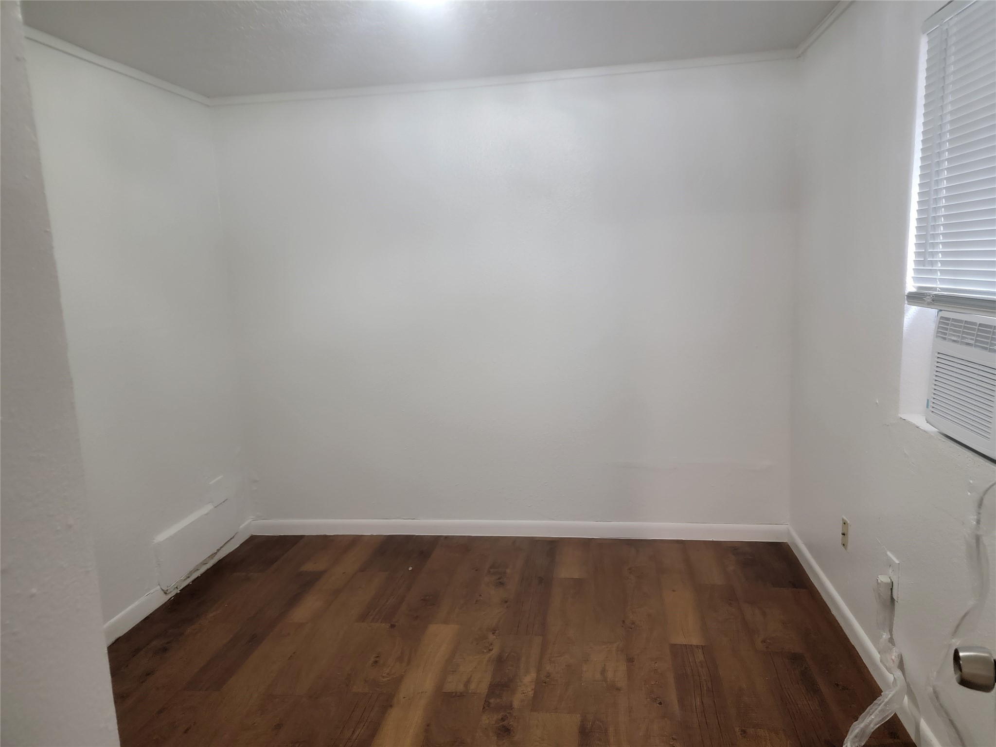 22536 Yancy Road Porter, TX 77365 - Photo 44 of 50 a view of an empty room with wooden floor and a window