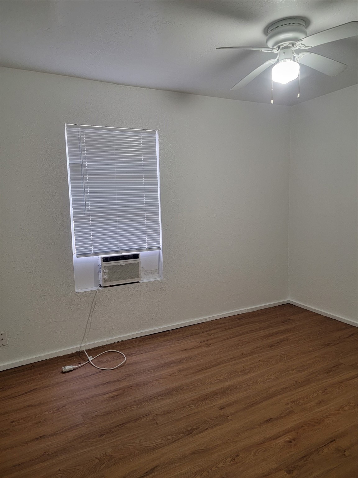 22536 Yancy Road Porter, TX 77365 - Photo 48 of 50 a view of an empty room with wooden floor and a window