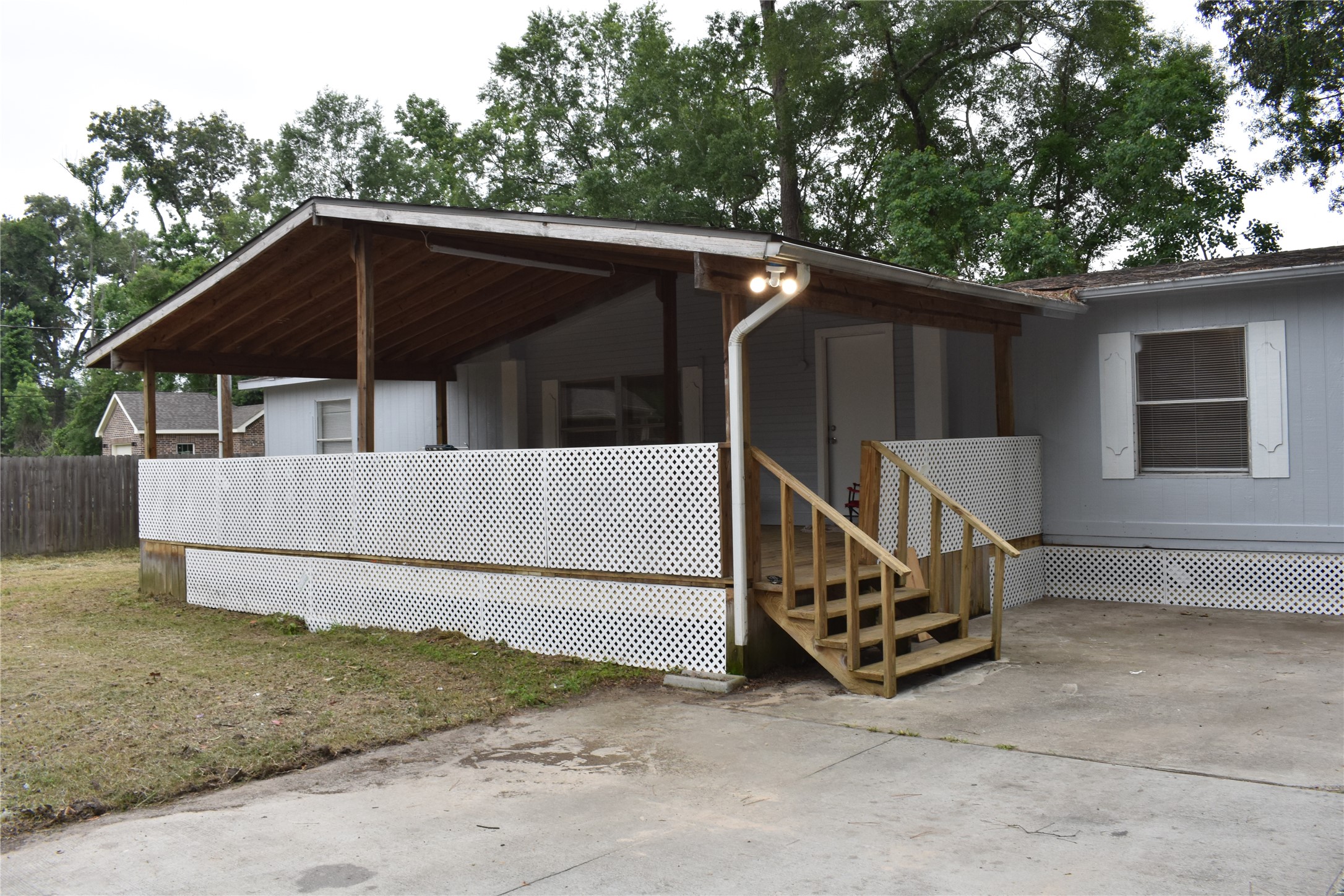 22536 Yancy Road Porter, TX 77365 - Photo 8 of 50 a view of backyard with small cabin and wooden fence
