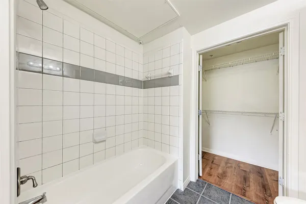 a bathroom with a bathtub and shower