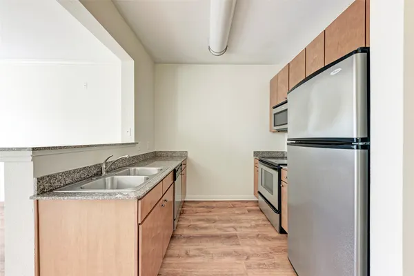 a kitchen with a refrigerator and a sink