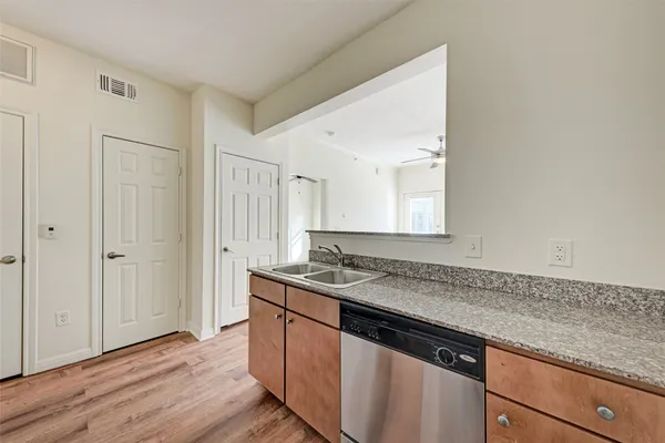 a kitchen with granite countertop a sink and cabinets
