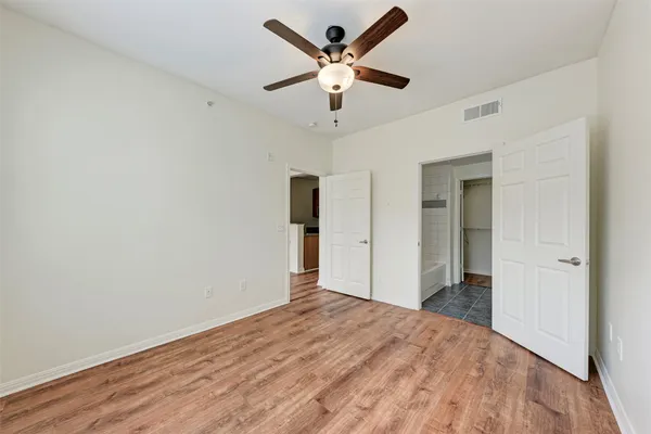 a view of empty room with wooden floor