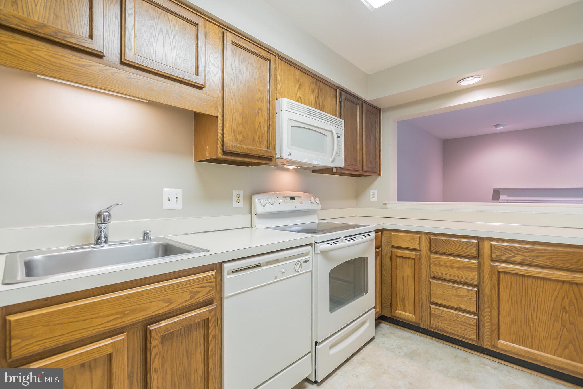 10717 Kings Riding Way, Unit 202 Rockville, MD 20852 - Photo 11 of 34 Kitchen with opening to den