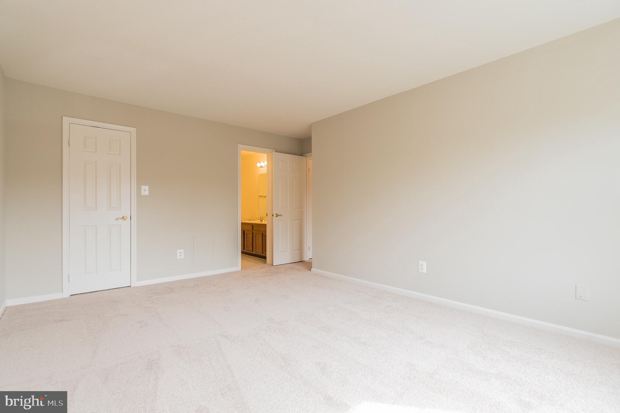 10717 Kings Riding Way, Unit 202 Rockville, MD 20852 - Photo 23 of 34 Owner's bedroom toward closet and bath