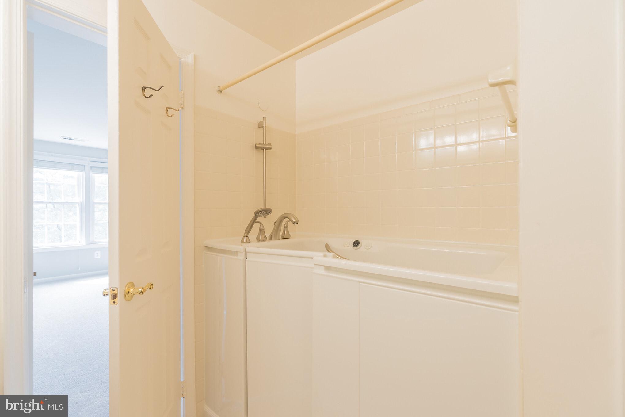 10717 Kings Riding Way, Unit 202 Rockville, MD 20852 - Photo 25 of 34 Walk in tub in owner's bathroom
