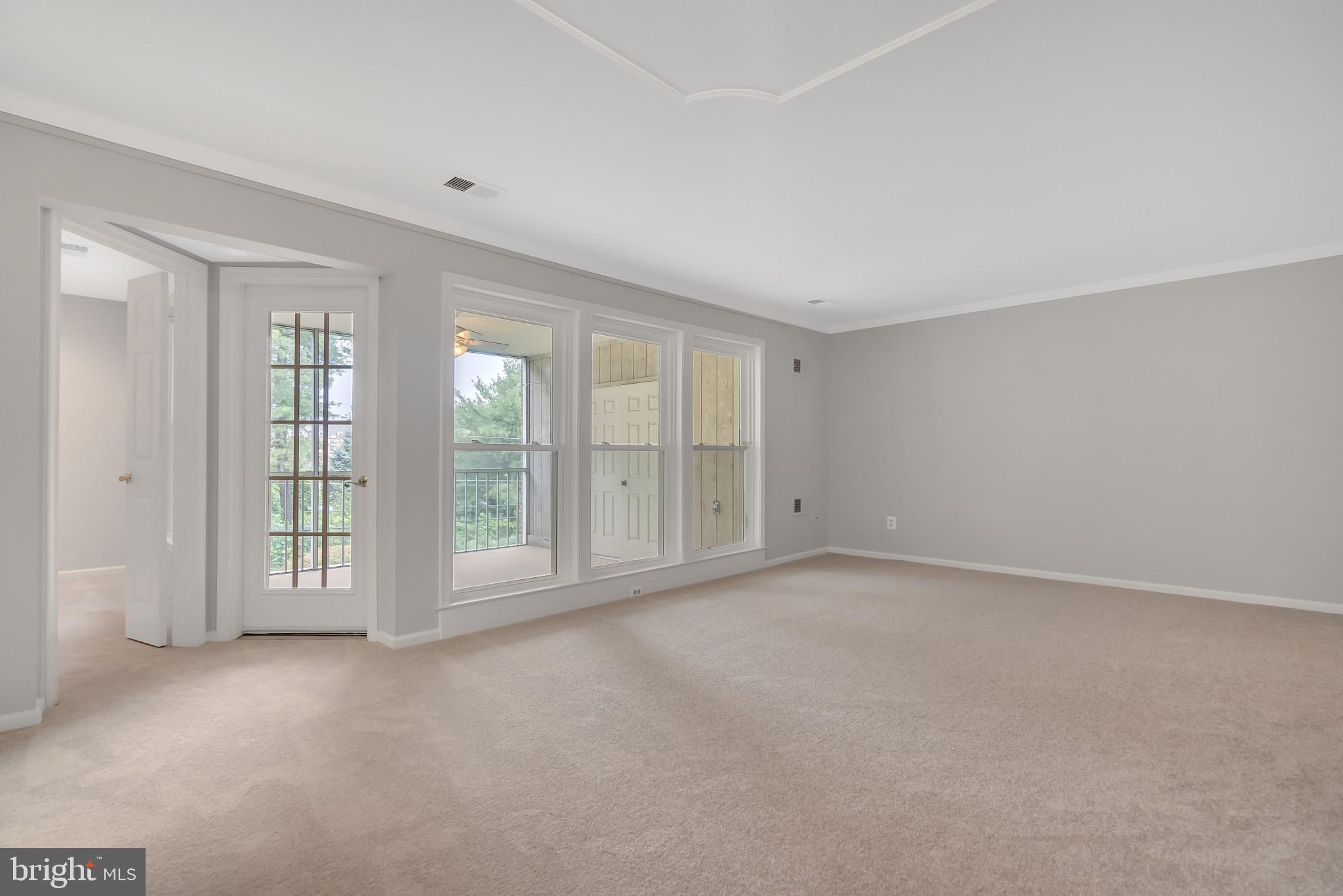 10717 Kings Riding Way, Unit 202 Rockville, MD 20852 - Photo 6 of 34 View of living room and porch from dining area