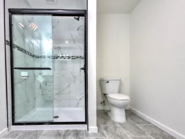 a bathroom with a glass shower door