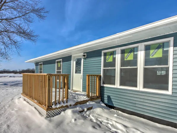 a view of a house with a small yard and wooden fence