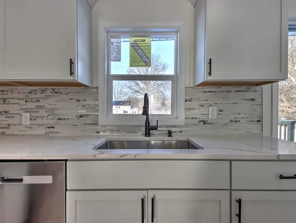 a kitchen with a sink and cabinets
