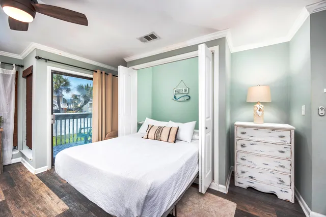 a bedroom with a large bed and a chandelier