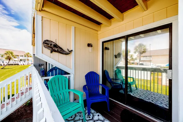 a view of an house with a backyard and a wooden deck