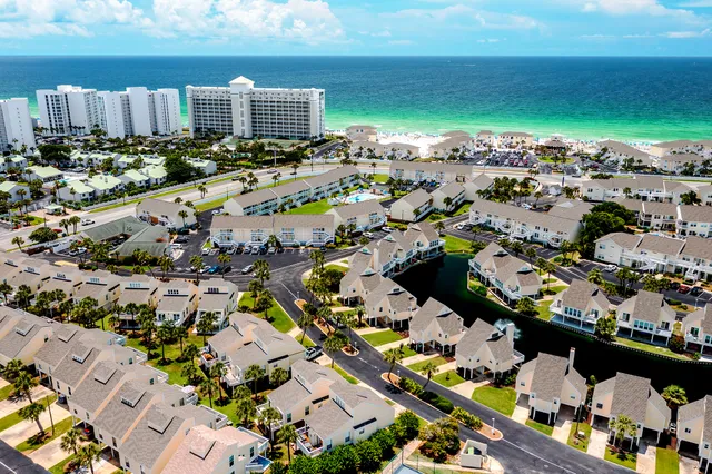 an aerial view of a swimming pool patio yard and lake view