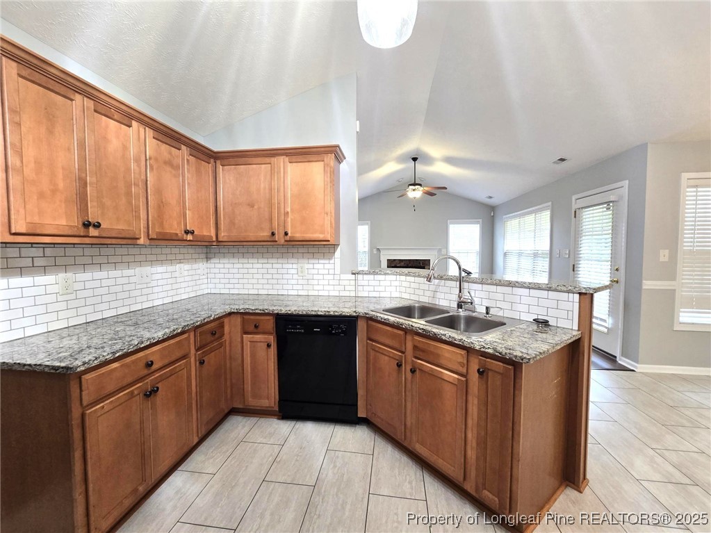 4158 Redspire Lane Fayetteville, NC 28306 - Photo 11 of 34 a kitchen with stainless steel appliances granite countertop a sink counter space cabinets and a large window