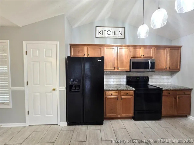a view of a kitchen with a sink and a stove top oven