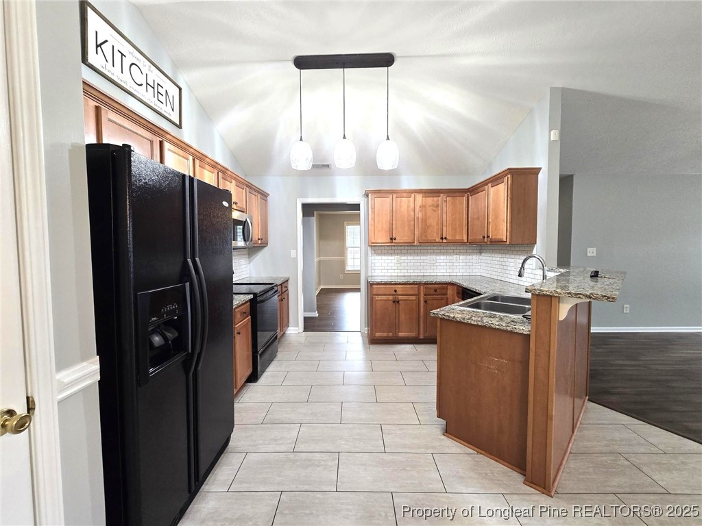 4158 Redspire Lane Fayetteville, NC 28306 - Photo 13 of 34 a kitchen with stainless steel appliances granite countertop a refrigerator a stove and a sink
