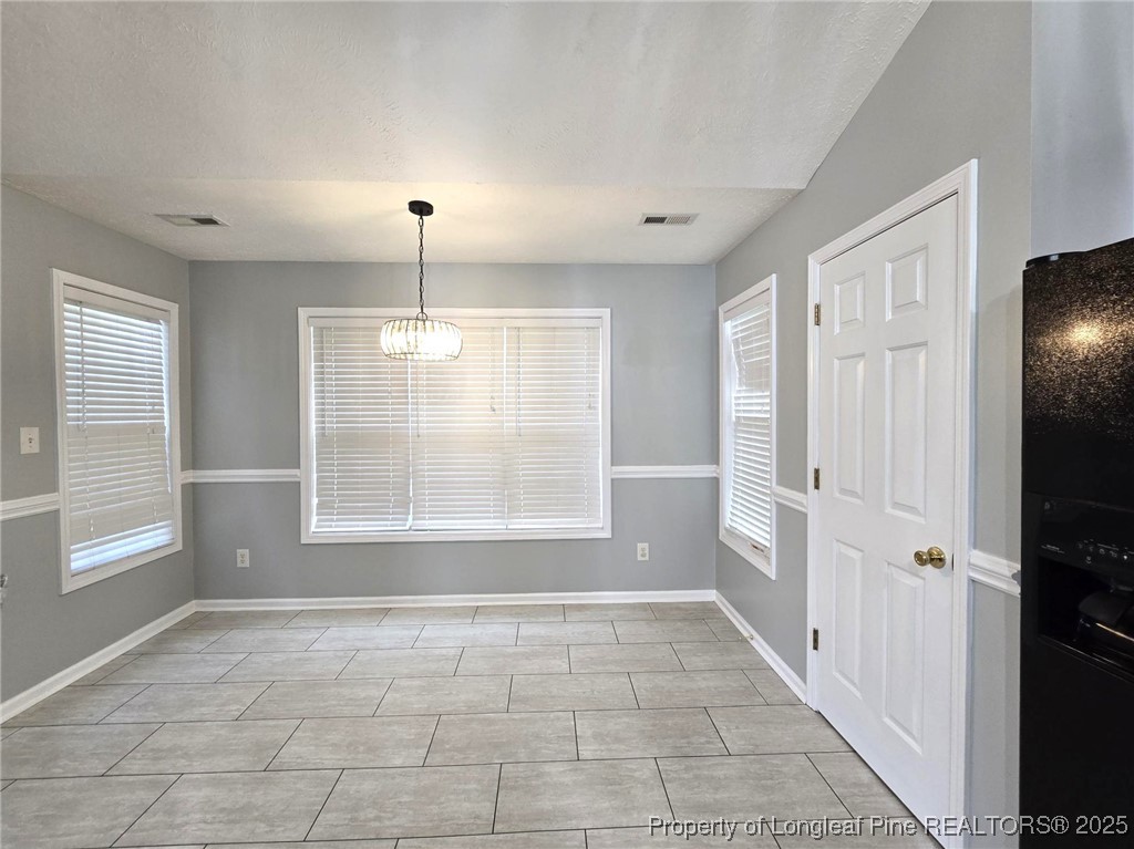 4158 Redspire Lane Fayetteville, NC 28306 - Photo 16 of 34 an empty room with wooden floor and windows