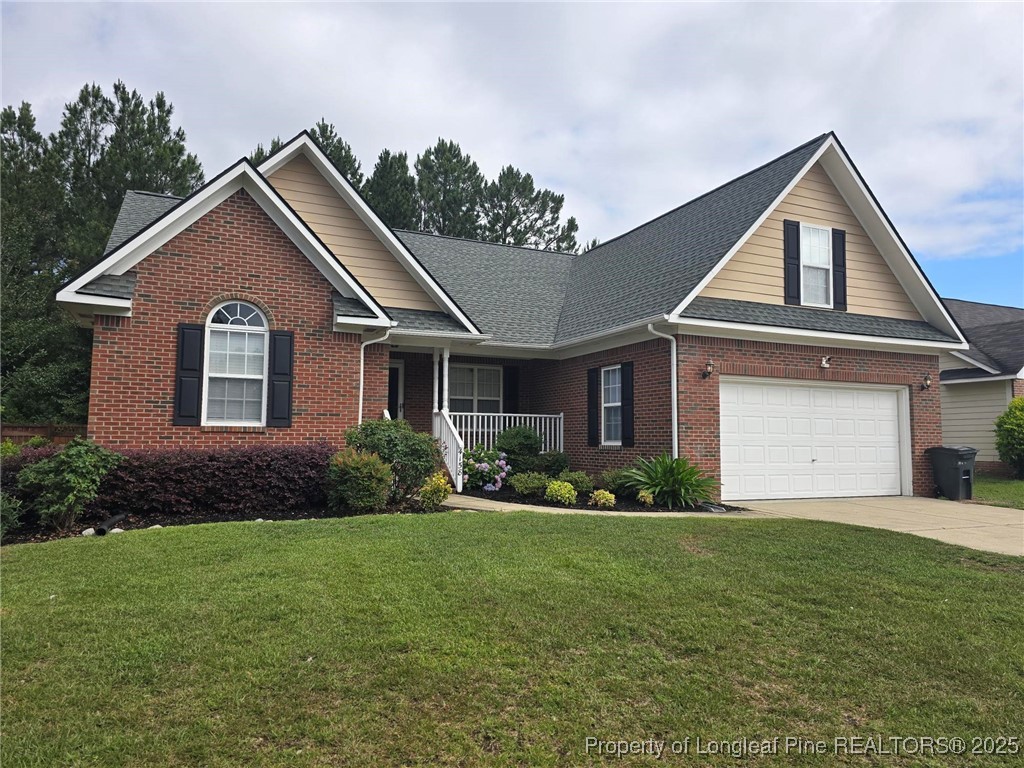 4158 Redspire Lane Fayetteville, NC 28306 - Photo 2 of 34 a front view of a house with a yard and garage