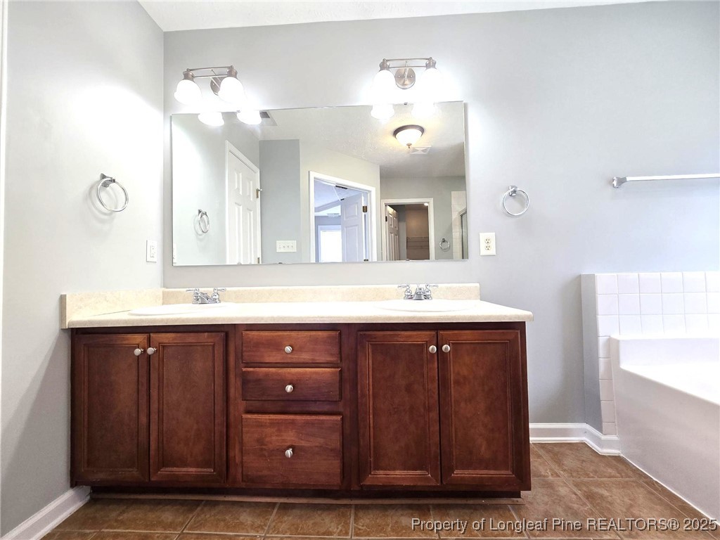 4158 Redspire Lane Fayetteville, NC 28306 - Photo 23 of 34 a bathroom with a sink double vanity and a mirror