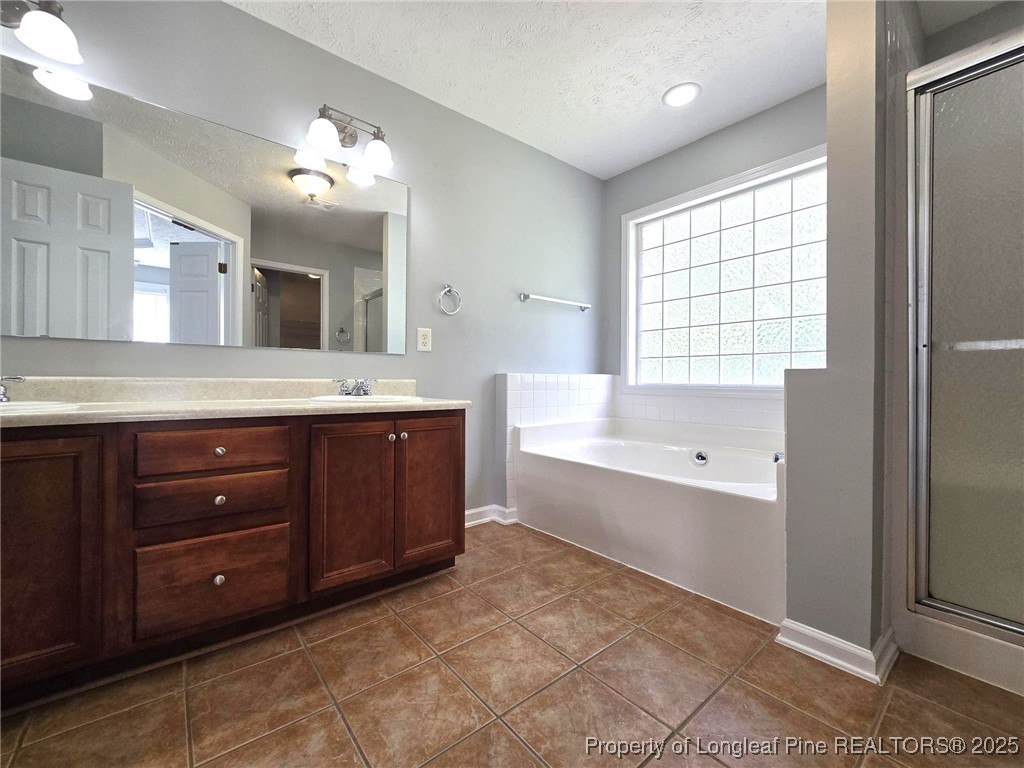 4158 Redspire Lane Fayetteville, NC 28306 - Photo 24 of 34 a spacious bathroom with a granite countertop sink mirror and bathtub