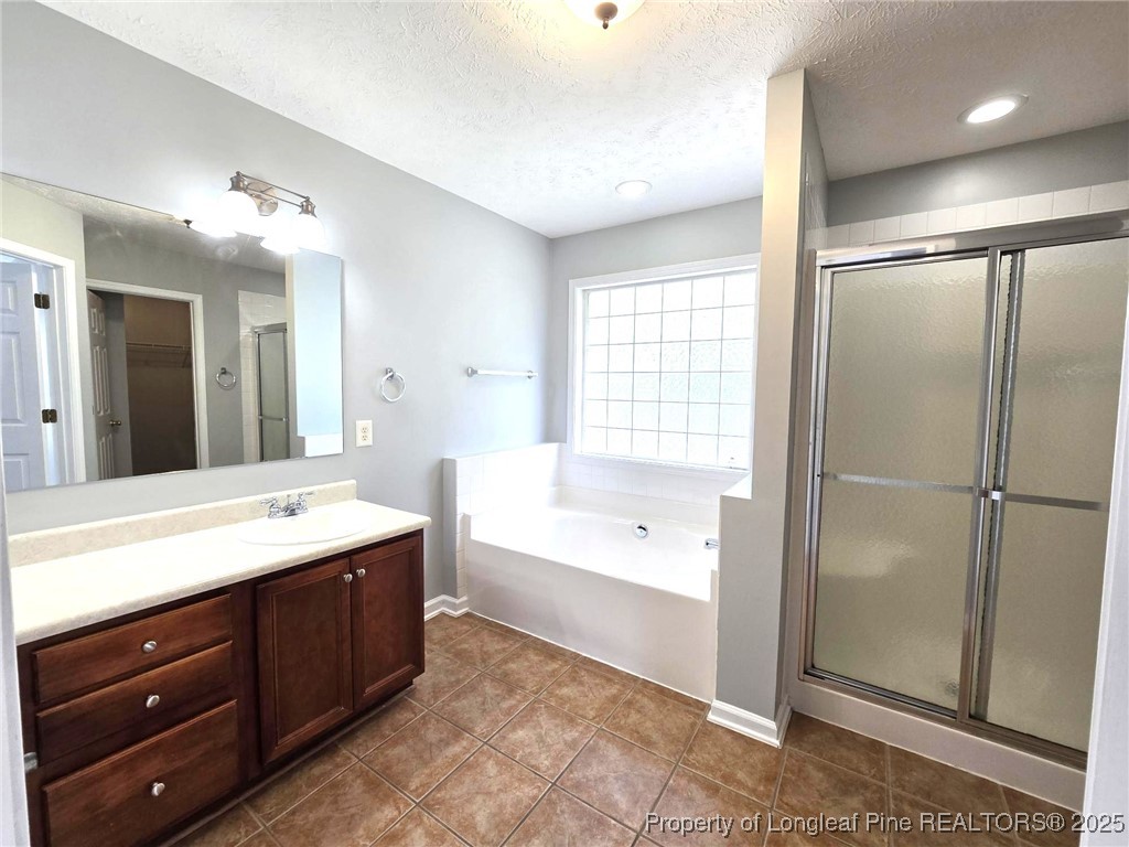 4158 Redspire Lane Fayetteville, NC 28306 - Photo 25 of 34 a spacious bathroom with a tub sink shower and mirror