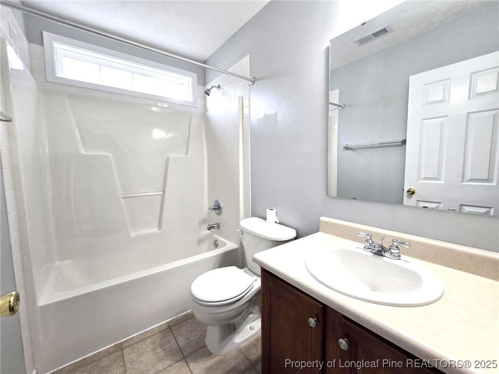 4158 Redspire Lane Fayetteville, NC 28306 - Photo 30 of 34 a bathroom with a sink a toilet and shower