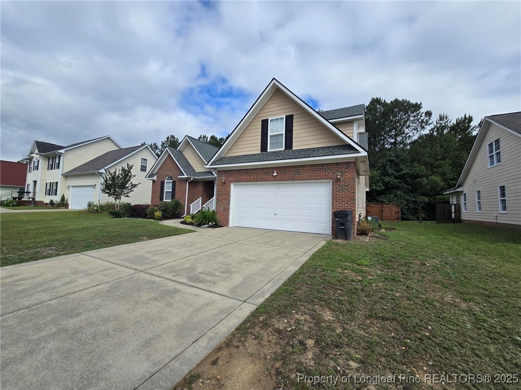 4158 Redspire Lane Fayetteville, NC 28306 - Photo 3 of 34 a front view of a house with a yard and garage
