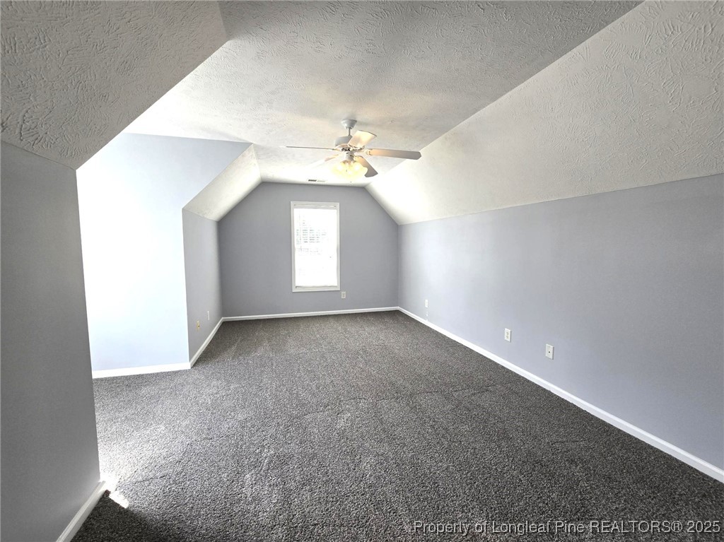 4158 Redspire Lane Fayetteville, NC 28306 - Photo 33 of 34 an empty room with a chandelier fan and windows