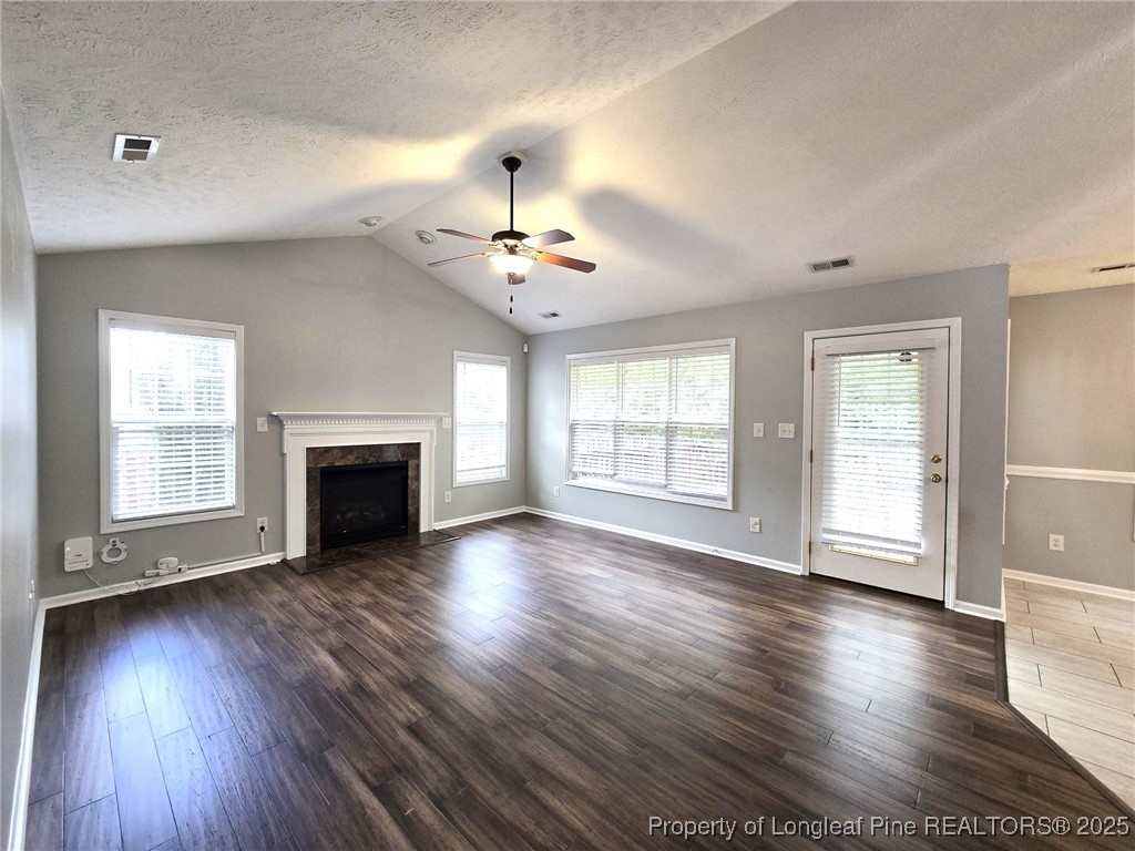 4158 Redspire Lane Fayetteville, NC 28306 - Photo 9 of 34 a view of an empty room with wooden floor and a window