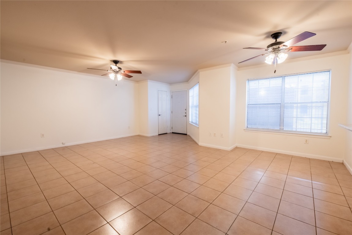 501 West 26th Street, Unit 106 Austin, TX 78705 - Photo 2 of 13 a view of an empty room with a chandelier fan