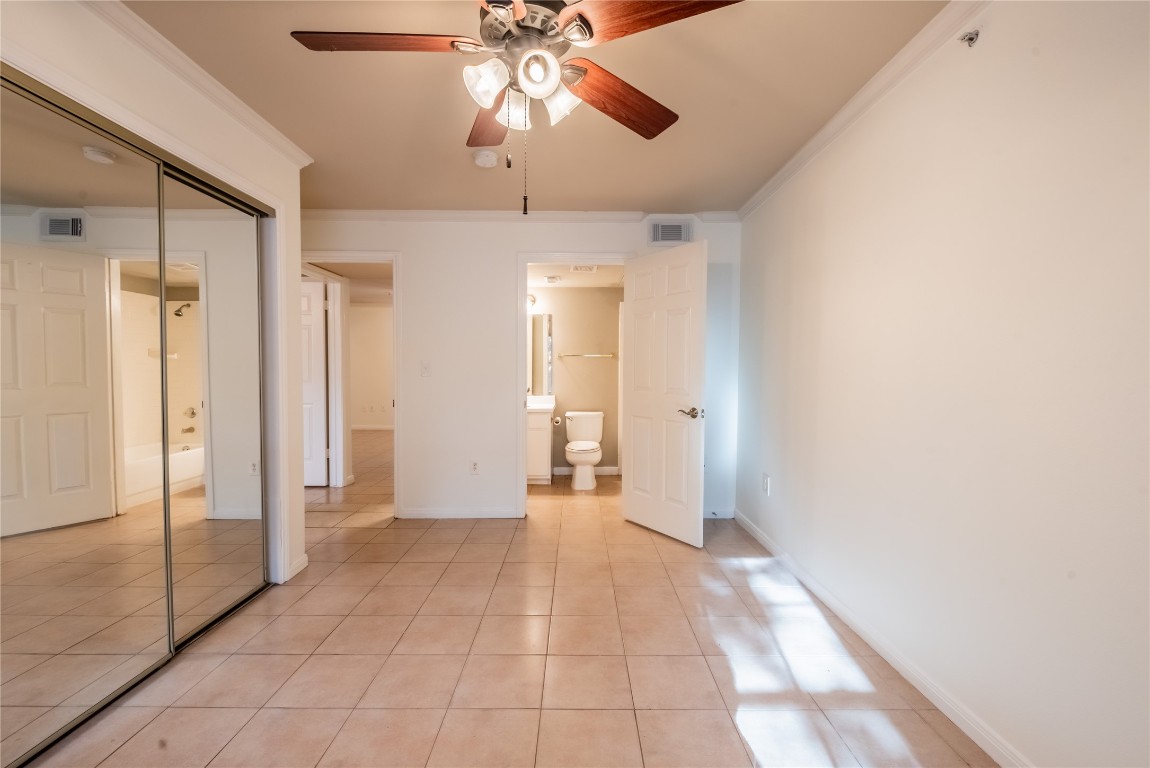 501 West 26th Street, Unit 106 Austin, TX 78705 - Photo 10 of 13 a view of a big room with a chandelier fan and windows